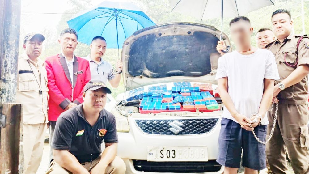 The accused and the seized contraband under police custody.
