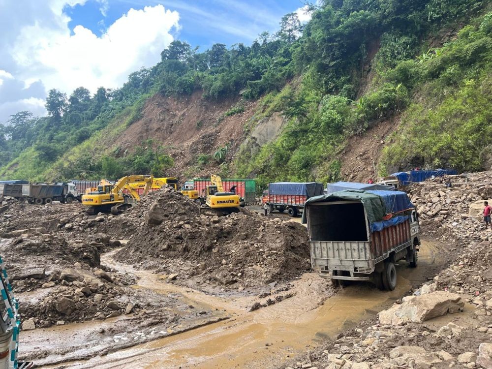 Trucks carrying essential commodities passes through Pherema landslide area along National Highway-29 between Kohima and Dimapur on September 5. (Morung Photo)