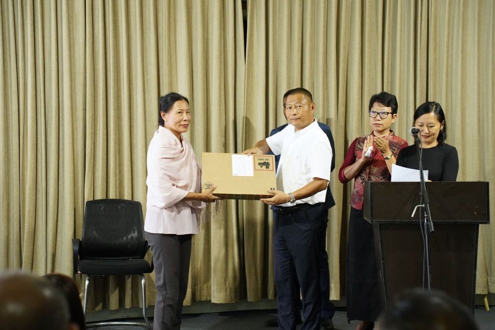 The School Education Advisor giving away laptops to a school representative.