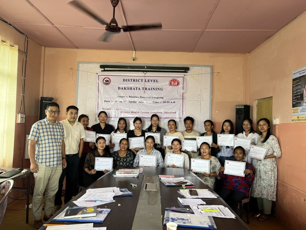 Dr Imtijungshi, DPO (RCH/UIP) with resource persons and participants.