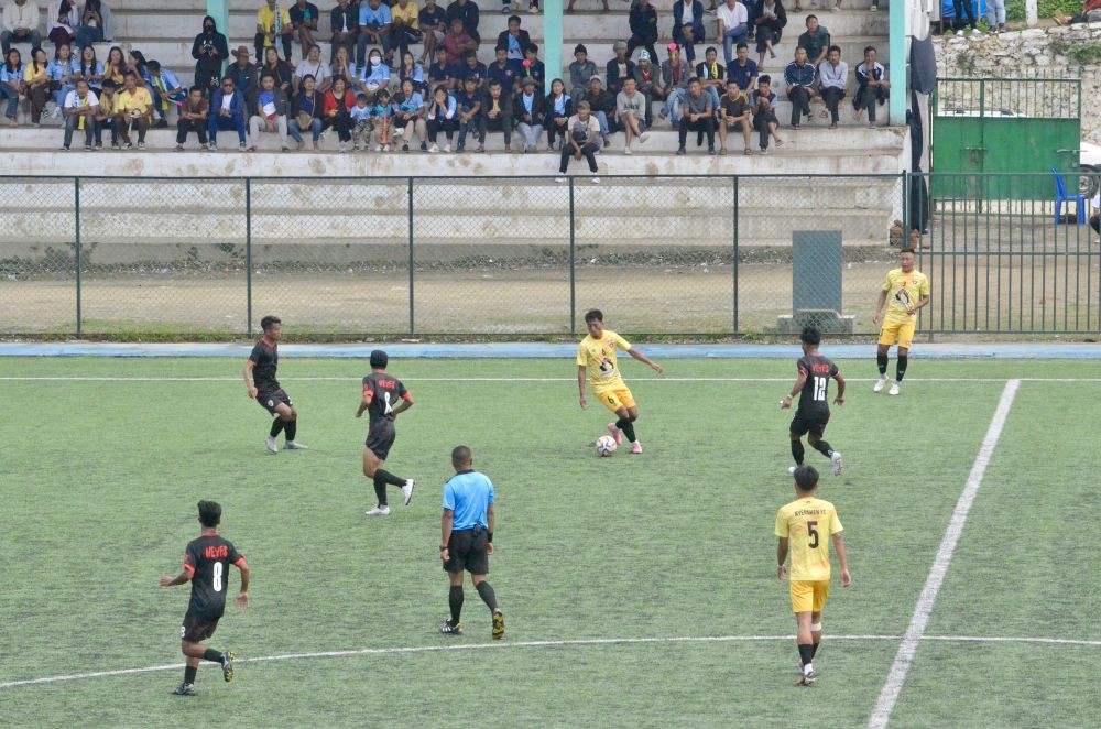 Nyenshen FC players in yellow and Northeast Youngster Football School in black jerseys on October 26 at 32nd Loyem Memorial Trophy in Tuensang. (Morung Photo)