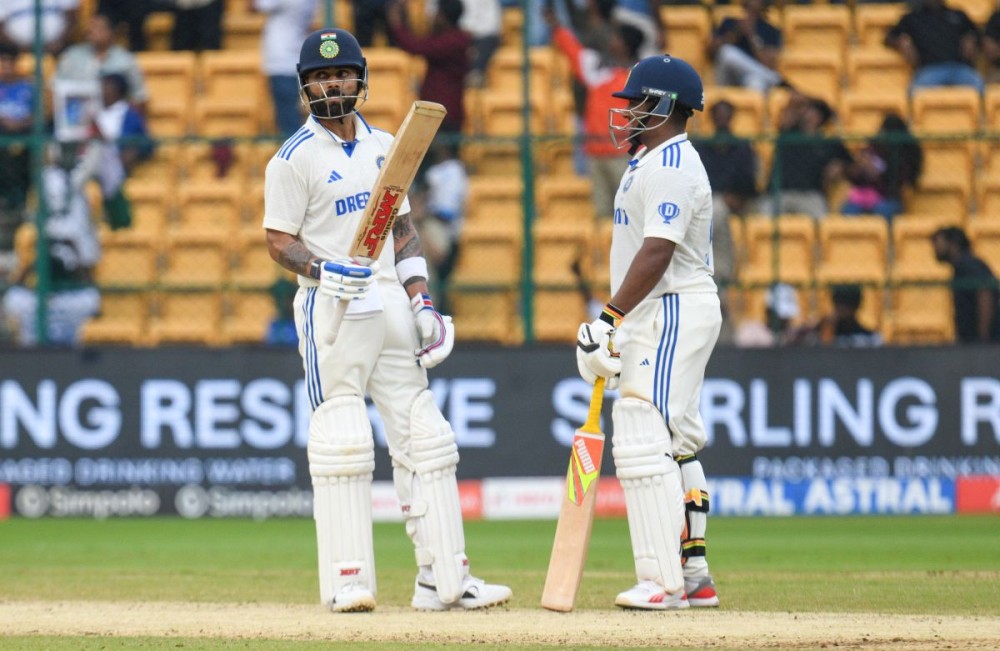 Bengaluru: India's Virat Kohli celebrates his half century during day three of the first cricket test match between India and New Zealand at the M.Chinnaswamy Stadium in Bengaluru on Friday, October 18, 2024. (Photo: IANS/Dhananjay Yadav)