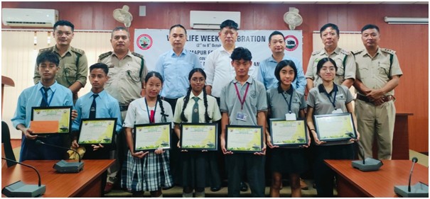 DFD officials along with winners of essay and painting competition.