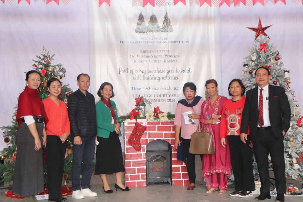 Participants of Kohima College’s “Winter Wonderland” fete pose amidst decorated Christmas trees and craft booths.