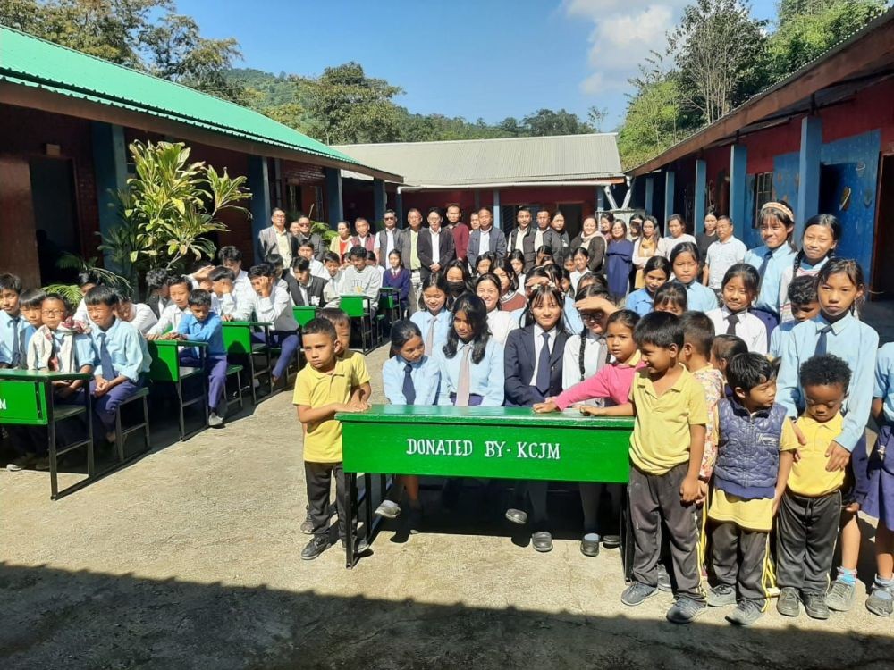 KCJM with others and students during the distribution of desk and benches to GHS Kandinu on November 4.
