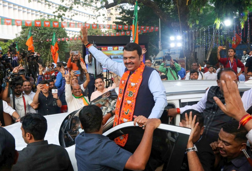 Mumbai: Maharashtra Deputy CM Devendra Fadnavis greets supporters following the Mahayuti alliance's victory in the Maharashtra Assembly elections in Mumbai on Saturday, November 23, 2024. (Photo: IANS)