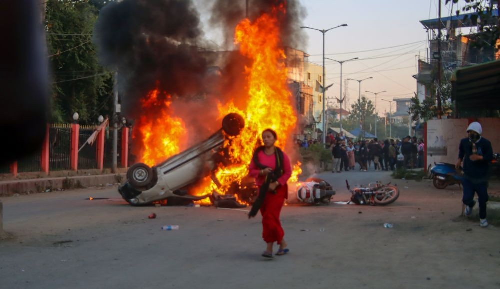 Jiribam: Smoke billows from a car set ablaze as protesters attacked the residence of Manipur Chief Minister N. Biren Singh, alongside homes of MLAs and ministers, engaging in vandalism and arson in Luwangshangbam on Sunday, November 17, 2024. (Photo: IANS)