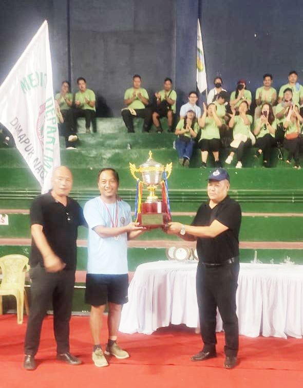 Commissioner of Police, Dimapur, Kevithuto Sophie handing the overall championship trophy to the Medical Department.