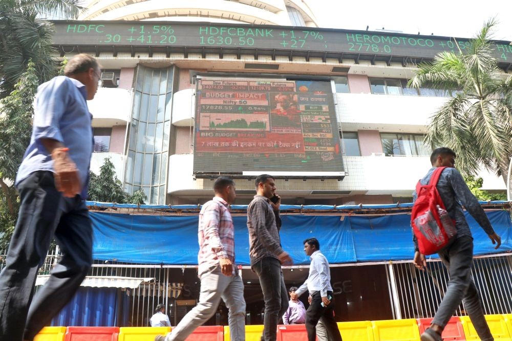 Mumbai: People walk past a screen showing stock market goes up outside BSE building at Dalal Street after the National Financial Budget presented by Finance Minister Nirmala Sitaraman, in Mumbai on Wednesday, Feb. 01, 2023.  (Photo: Nitin Lawate/IANS)