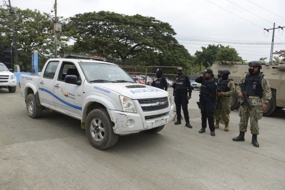 Police officers stand guard outside the Litoral Penitentiary after clashes occurred in the prison in Guayaquil, Ecuador, Nov. 13, 2021. (Photo by Marcos Pin/Xinhua/IANS)