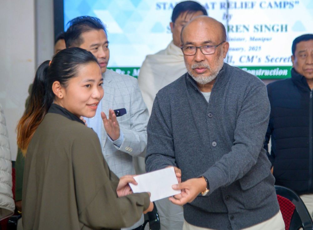 Imphal: Manipur Chief Minister N. Biren Singh distributes benefits to labour card holders under the Special Scheme for Providing Financial Assistance for the Education of Children of Labour Card Holders staying at relief camps, in Imphal on Wednesday, January 8, 2025. (Photo: IANS)