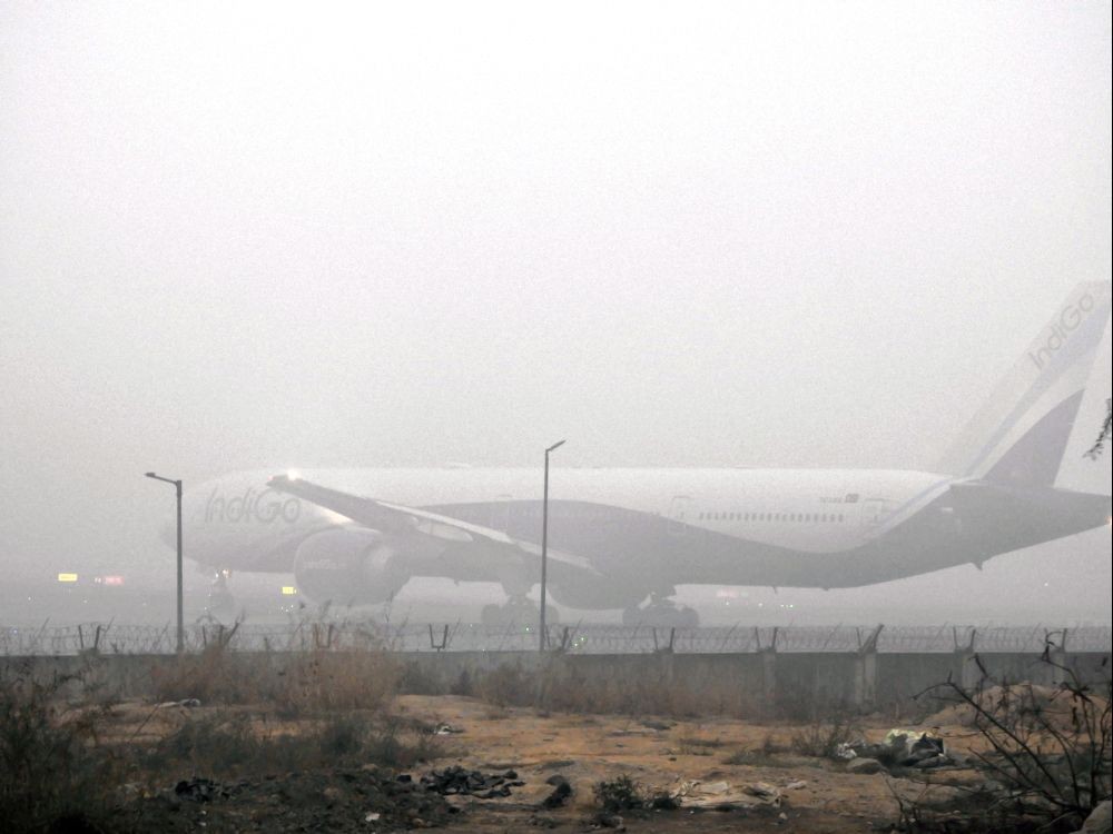 New Delhi: An airplane stands at the airport as fog engulfs the area on a cold winter morning in New Delhi on Friday, December 29, 2023. (Photo: IANS/Anupam Gautam)