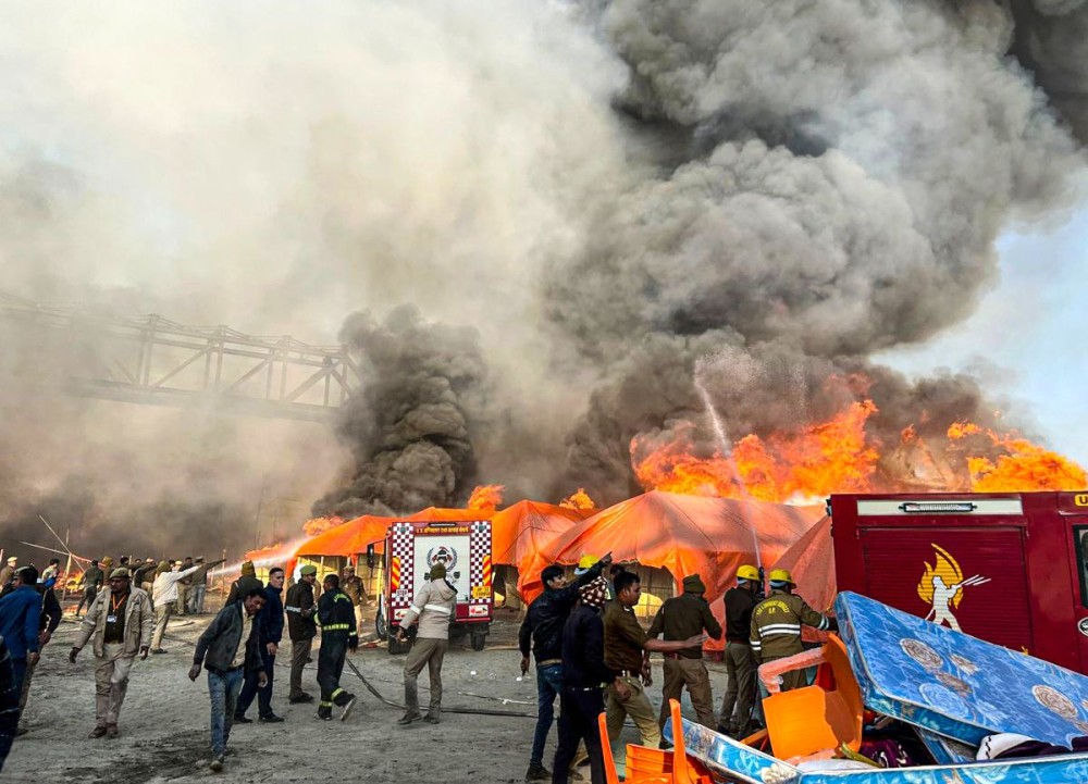 Prayagraj: Firefighters attempt to douse flames after a fire broke out at a camp during the Maha Kumbh Mela 2025 in Prayagraj on Sunday, January 19, 2025. (Photo: IANS)