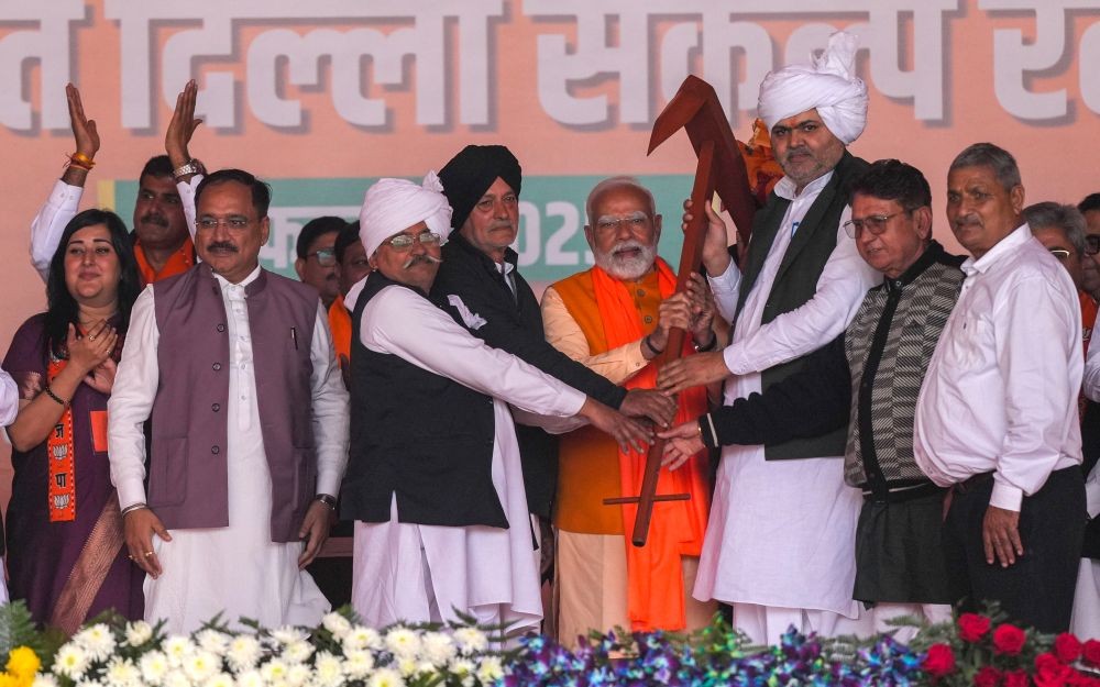 New Delhi: Prime Minister Narendra Modi with Delhi BJP President Virendra Sachdeva, party MPs Bansuri Swaraj, Ramvir Singh Bidhuri, and other leaders, during a public meeting ahead of the Delhi Assembly Elections in RK Puram, New Delhi, on Sunday, February 2, 2025. (Photo: IANS/Amarjeet Kumar Singh