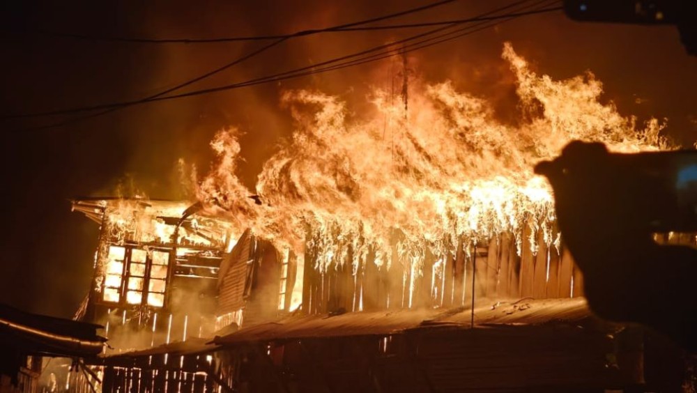 One of the razed buildings engulfed in flames during the fire at the main market centre in Tuensang on the night of February 14.