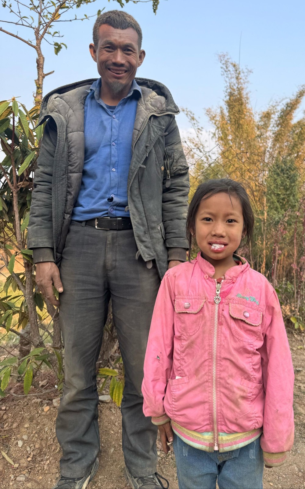 6-year-old Chongkom from Peshu village with her father.