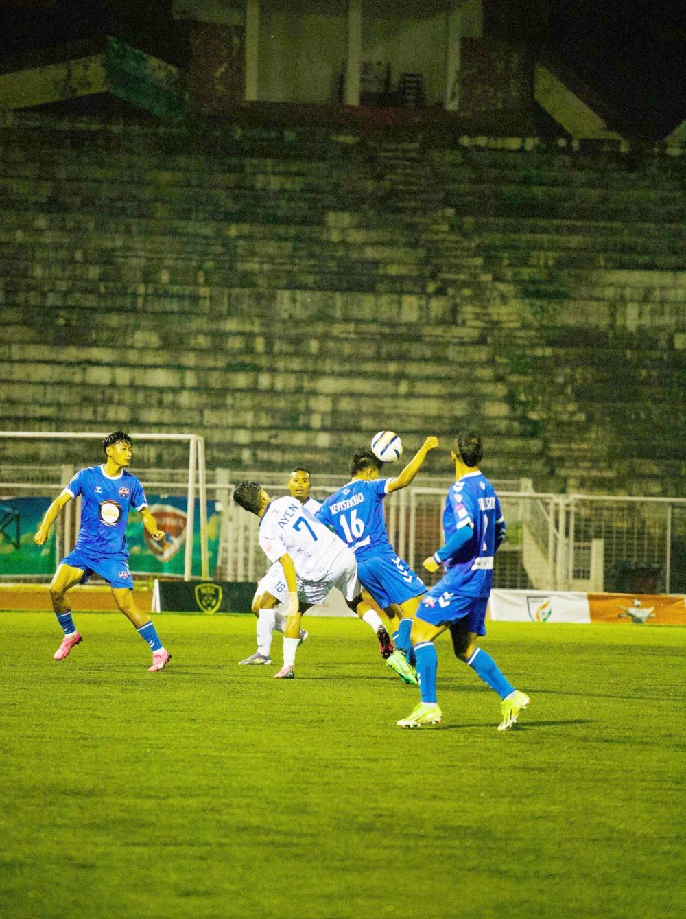 Players of Sechü Zubza FC (in blue) and Frontier Warriors FC (in white) battle for possession during their Matchday 13 encounter in the ongoing Nagaland Super League (NSL) at Indira Gandhi Stadium, Kohima on March 12. (Photo Courtesy: @NSLOfficial2024/X)