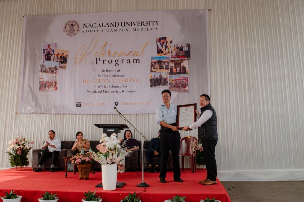 Prof. Glenn T. Thong receives a memento during his retirement programme.