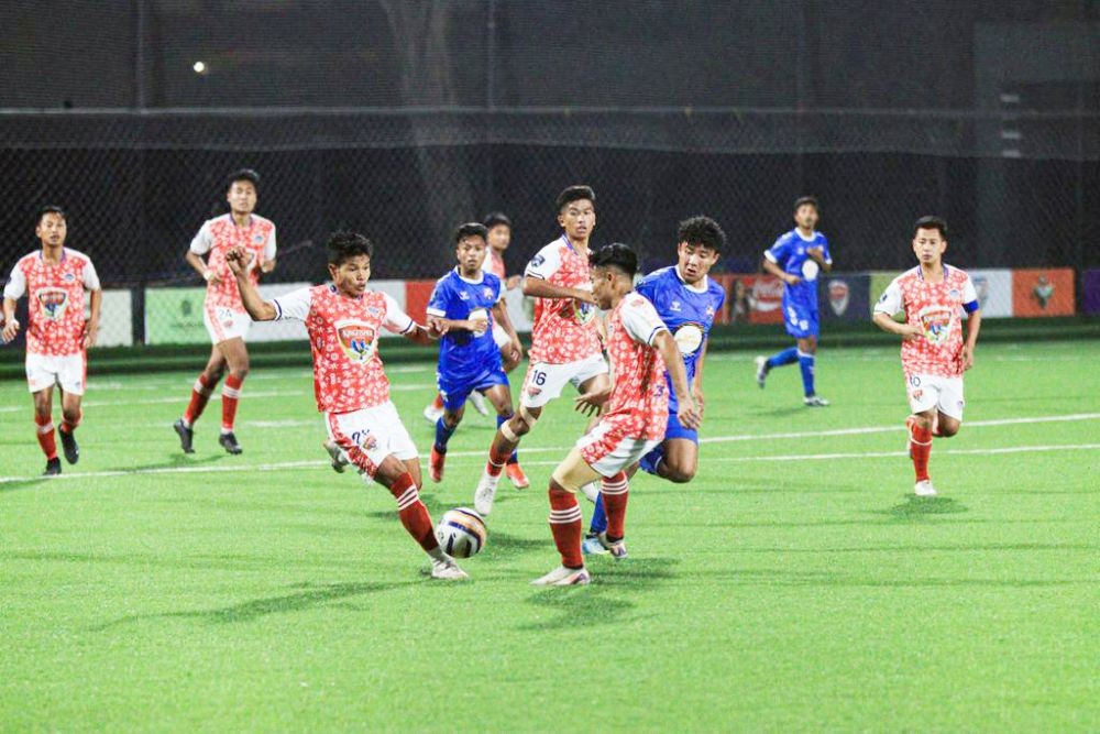Nagaland United SC (in red) and Sechu Zubza FC (in blue) players vie for possession during their encounter on the Match Day 10 of the ongoing Nagaland Super League (NSL) at Chümoukedima Football Stadium on March 1. (Photo Courtesy: NSL Media)