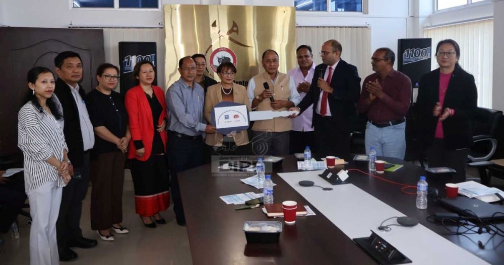 Principal Director, Health & Family Welfare, Dr E. Motsuthung Patton handing over the Mobile Medical Unit vehicle key to CMO Kiphire on March 26. (DIPR Photo)