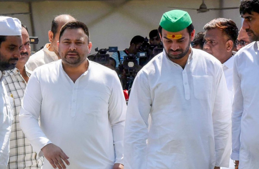 Patna: Leader of the Opposition Tejashwi Yadav and RJD MLA Tej Pratap Yadav leave after addressing a press conference outside the Bihar Assembly in Patna on Wednesday, March 19, 2025. (Photo: IANS)