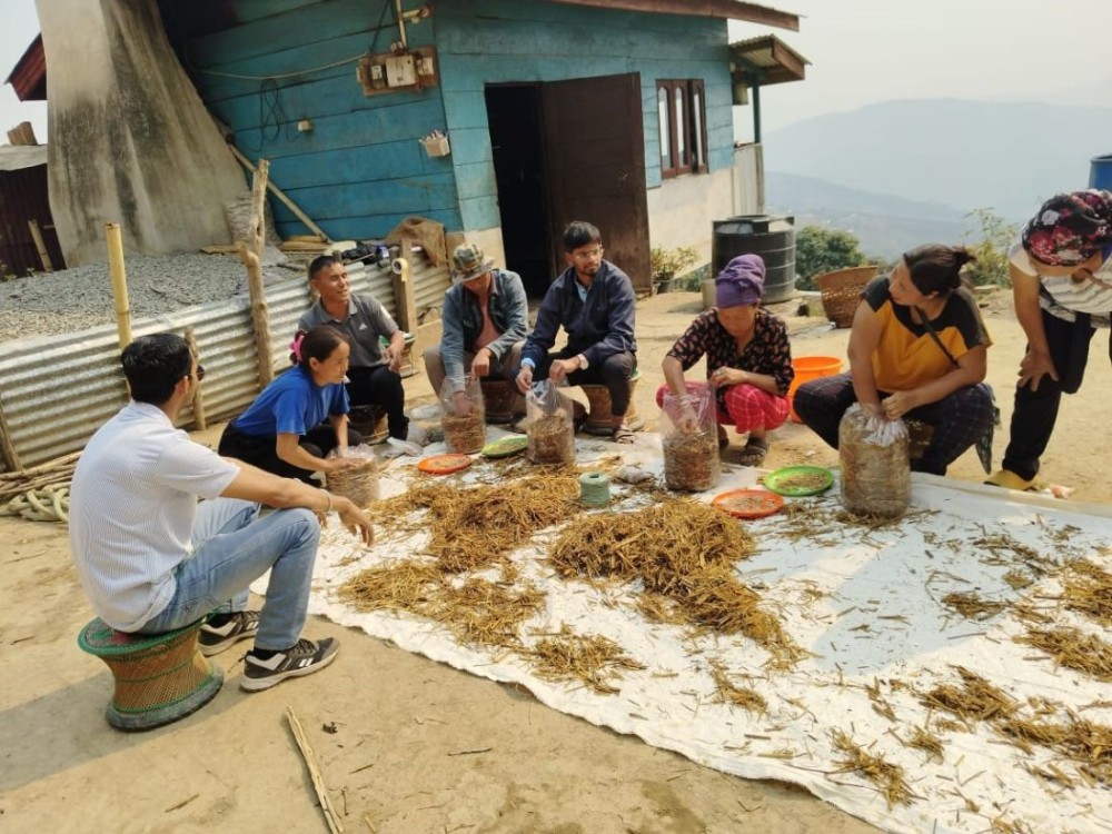 Dr Karibasappa CS, SMS (Plant Protection), leading a hands-on training session on mushroom bag preparation, providing practical learning for participants.