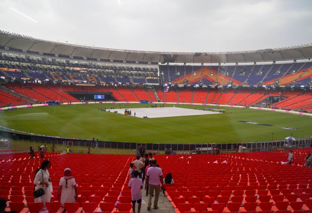 Pitch is seen covered as the start of the IPL match between Gujarat Titans and Kolkata Knight Riders delays due to bad weather at Narendra Modi Stadium, in Ahmedabad, Monday, May 13, 2024.(IANS/Siddharaj Solanki)