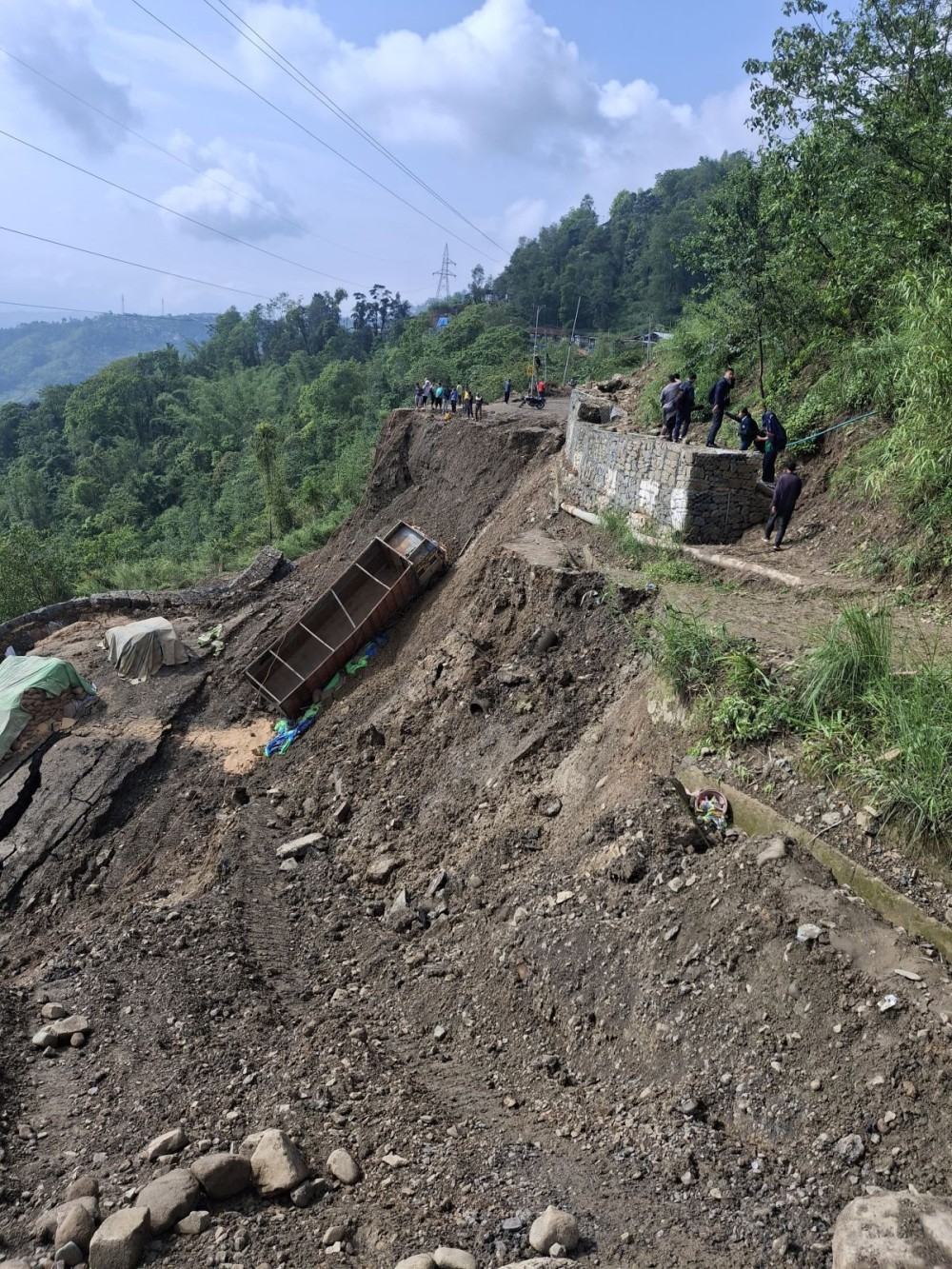 Students walk past totally collapsed National Highway–2 stretch  at Phesama near Naga Heritage Village Kisama on June 2. Extreme monsoon weather occurrences have caused widespread damages throughout the State, the Nagaland State Disaster Management Authority informs on June 3. (Morung Photo)