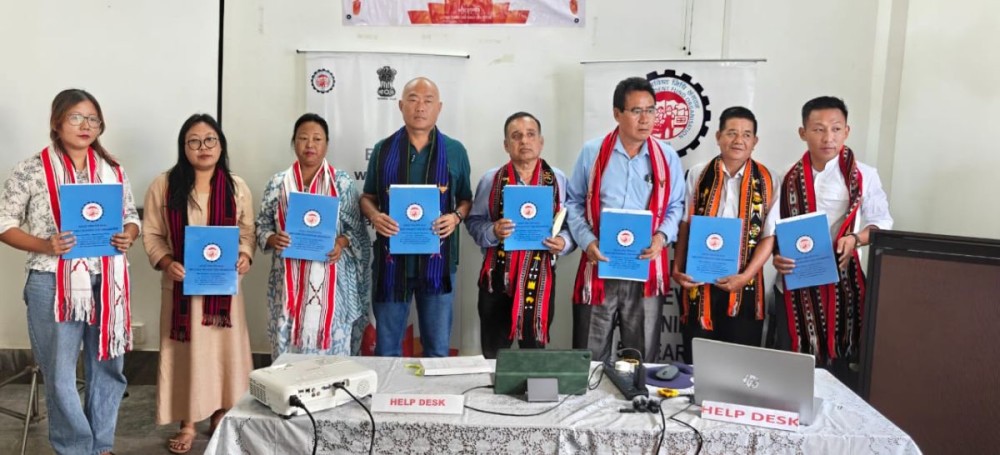 Officials and stakeholders display EPFO handbooks during the Nidhi Aapke Nikat outreach program organised by EPFO Dimapur at NSMDC Conference Hall in Kohima on June 27.