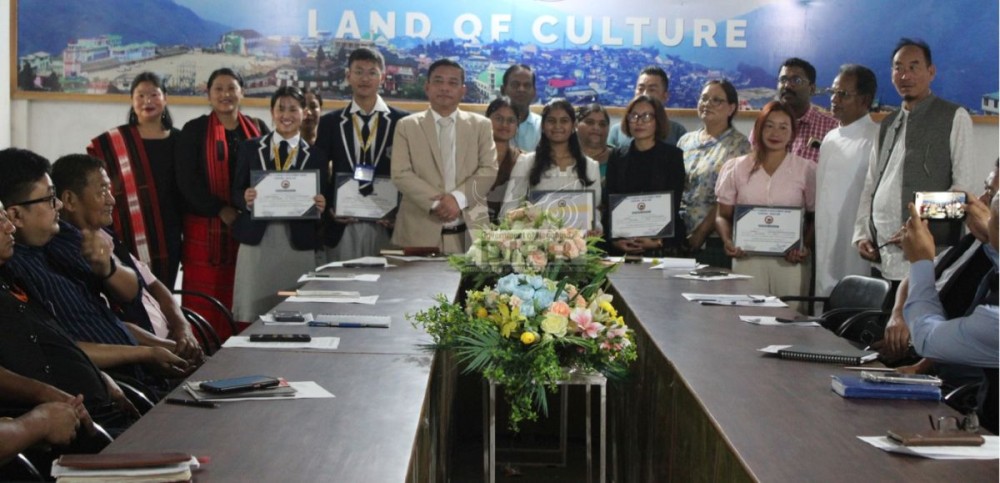 Minister P Bashangmongba Chang along with the DC Tuensang, meritorious students, parents and teachers at the felicitation function. (DIPR Photo)
