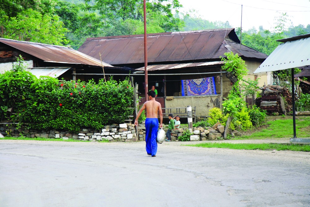 A Naga boy walks home with drinking water collected from a nearby stream, May 31, about 15 Kms towards Kohima. (Sorei Mahong/Photo)