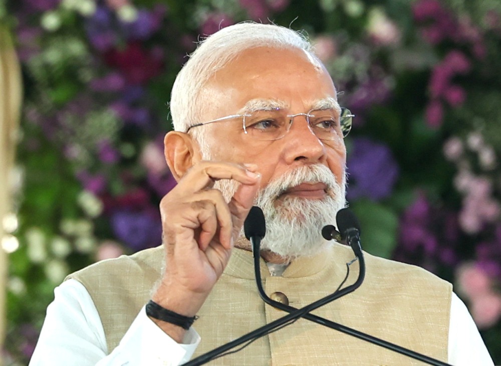 Prime Minister Narendra Modi addresses the gathering during the inauguration of green mobility initiatives, in Hansalpur, Ahmedabad, Gujarat, Tuesday, August 26, 2025. (Photo: IANS/PMO)