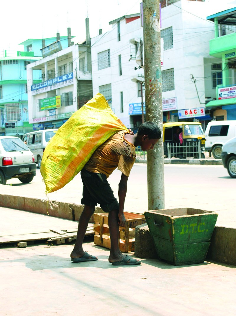 A rag-picker peers into a street dustbin in Dimapur, on Thursday, June 11, on the eve of ‘World Day Against Child Labour’. The International Labour Organization (ILO) has estimated that some 165 million children are engaged in child labour. This year, the World Day Against Child Labour, to be observed on June 12, will address the need for action to tackle the worst forms of child labour. (Photo/Caisii Mao)