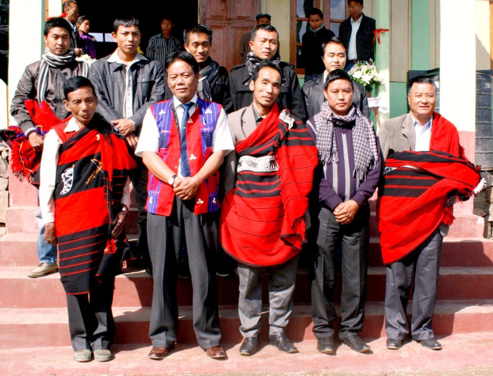 Chief guest Moasangba Jamir (standing second left, front) with Chuchuyimpang and Longra Village Council members and student leaders from AKM and OKM after the inauguration of Longra village’s community hall on January 14. (Morung Photo)