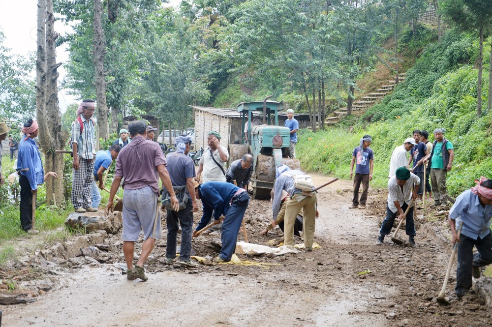 Volunteers are seen here repairing the neglected and depilated NH 702D, popularly known as Mariani Road. Volunteers from three villages of Aliba, Chungtia and Kinunger repaired a 35-kilometer stretch of the state’s second busiest highway on May 28. (Morung Photo)