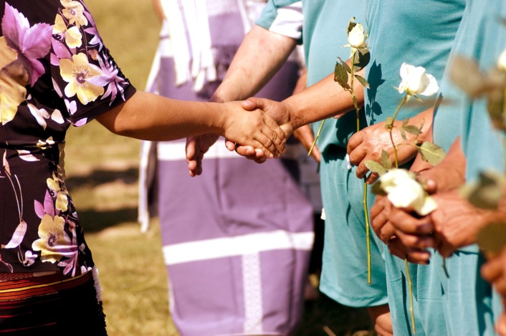 A woman – widowed by factional violence – shakes hands with representatives of the Naga “political groups” (faction) as widows presented white roses to each of the representatives at the start of the Naga Reconciliation Soccer match, held at DDSC, Dimapur on November 13. (Photo/Kazu)