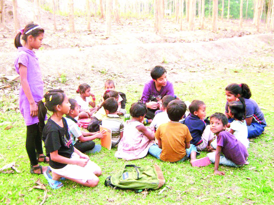 A volunteer teacher with some of the Lighthouse beginners, in their open air class.