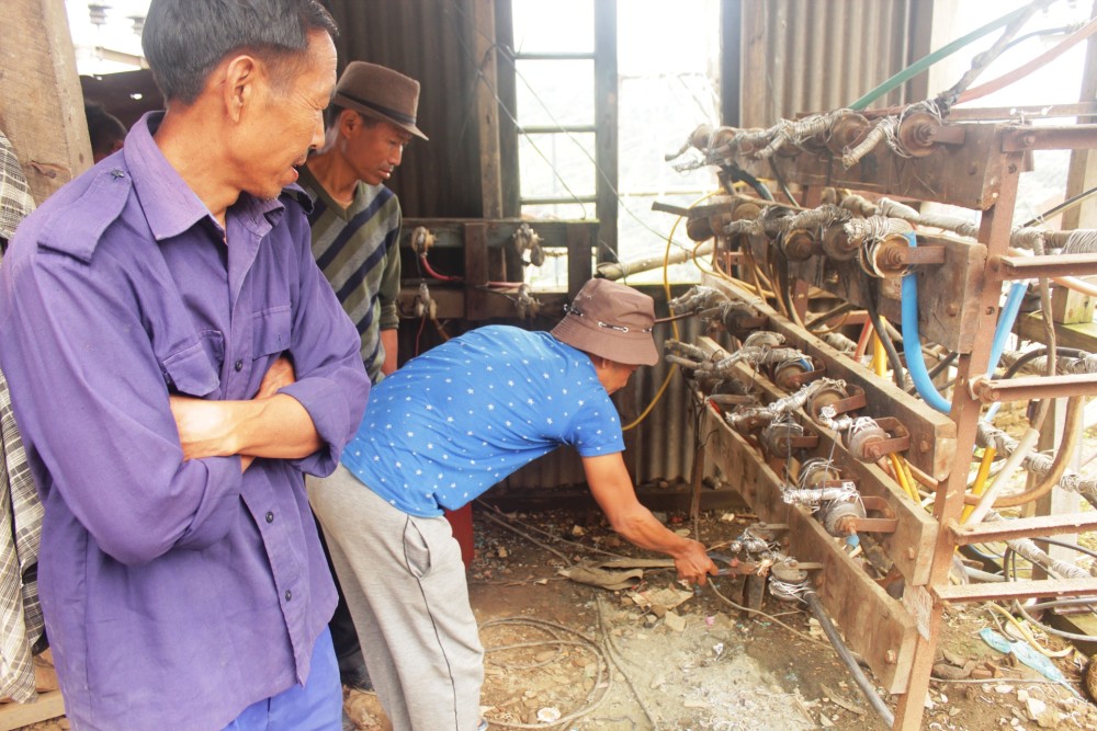 A staff of power department while on duty repairs live wire with - a plier. (Morung Photo)