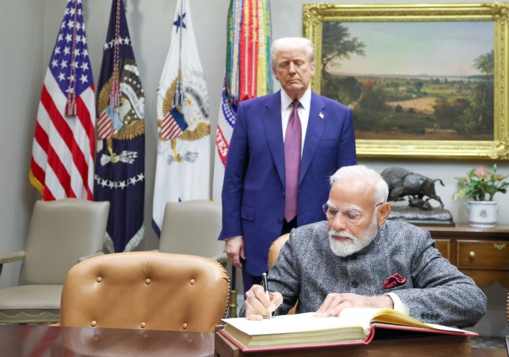Washington, DC: Prime Minister Narendra Modi signs a document in the presence of U.S. President Donald Trump in Washington, DC, on Friday, February 14, 2025. (Photo: IANS)