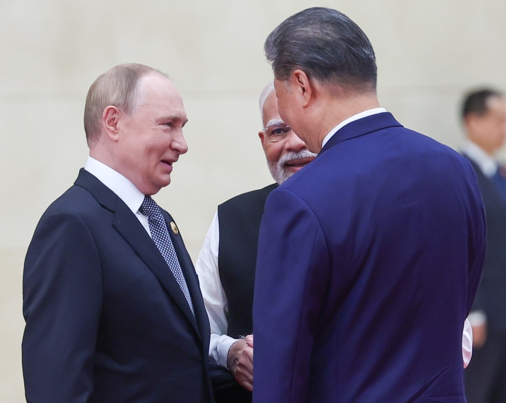 Russian President Vladimir Putin, Indian Prime Minister Narendra Modi and Chinese President Xi Jinping share a moment during their meeting on the sidelines of the Shanghai Cooperation Organisation (SCO) summit in Tianjin, September 1. (IANS Photo)