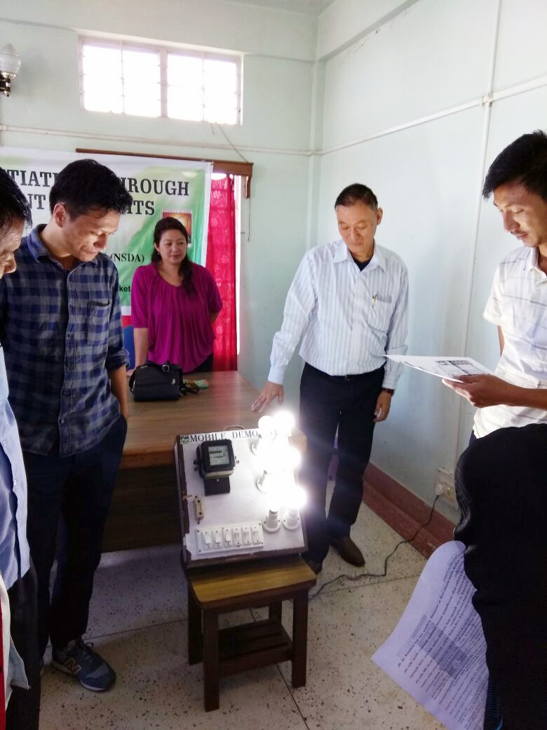 Visiting officials from the Electrical Inspectorate Kohima demonstrating the difference between power consumption by normal incandescent bulbs and LED bulbs during the Green Village Initiative held at Mopungchuket village, Mokokchung on October 5. (Morung Photo)