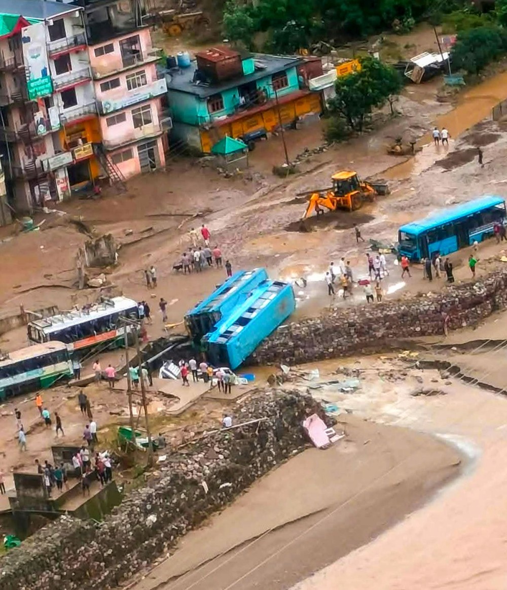 Mandi: Damaged buses and vehicles  after a cloudburst-triggered flood in Son Khad wreaked havoc at Dharampur bus stand in Mandi district, Tuesday, September 16, 2025. (IANS)