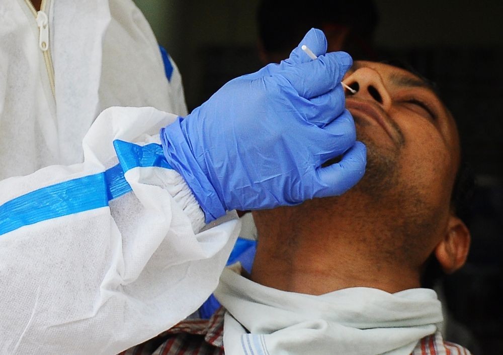 New Delhi: A healthcare worker collects a swab sample of a man for Covid-19 test, amid a sudden spurt in COVID 19 cases, in New Delhi, on Thursday, April 13, 2023.(Photo: Qamar Sibtain/IANS)
