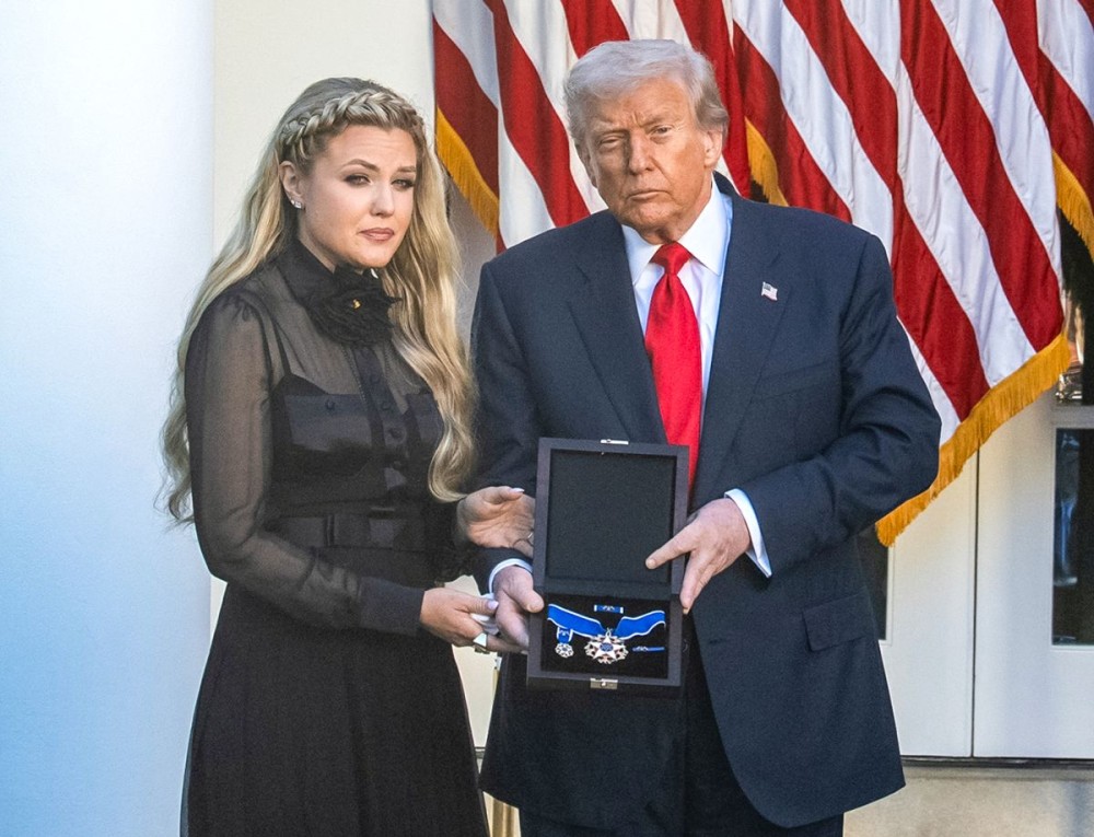 Washington: U.S. President Donald Trump (R) presents the Presidential Medal of Freedom to Erika Kirk during a ceremony to posthumously award the medal to Charlie Kirk, in the Rose Garden of the White House, in Washington, D.C., the United States, Oct. 14, 2025. (Photo: IANS/Xinhua/Hu Yousong)