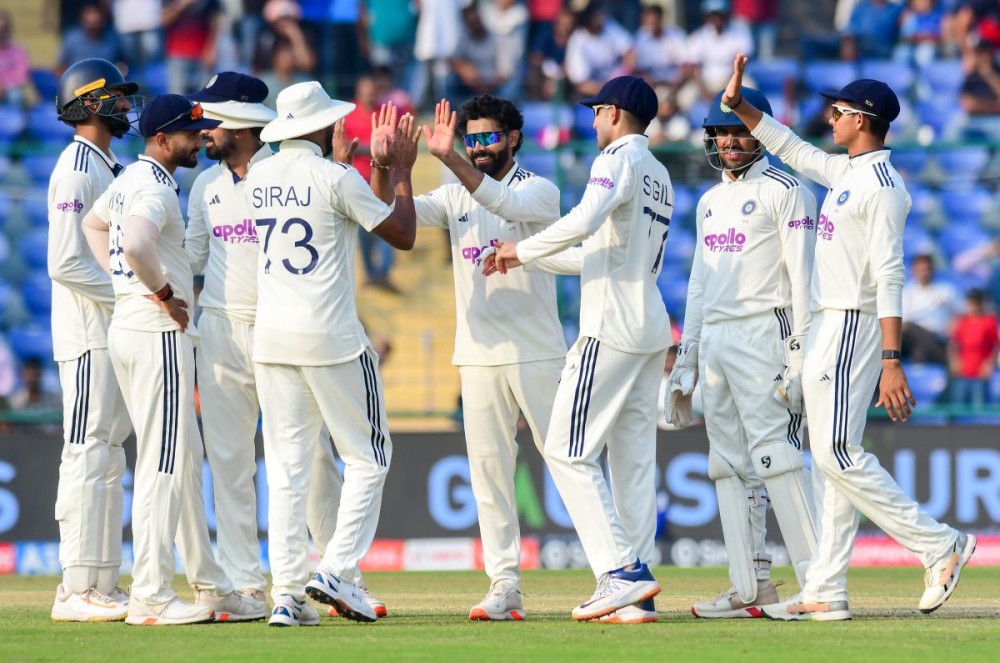 New Delhi: India's Ravindra Jadeja celebrates with teammates after taking the wicket of West Indies' captain Roston Chase during the second day of the second cricket test match between India and West Indies at the Arun Jaitley Stadium in New Delhi, Saturday, October 11, 2025. (Photo: IANS/Qamar Sibtain)
