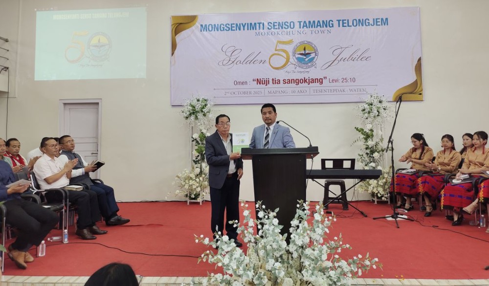Tongpang Ozüküm, MLA & Advisor for Water Resources, unveiling the Golden Jubilee souvenir during the celebration of Mongsenyimti Senso Tamang Telongjem (MSTT), Mokokchung, held at WATEM on October 2. (Morung Photo)