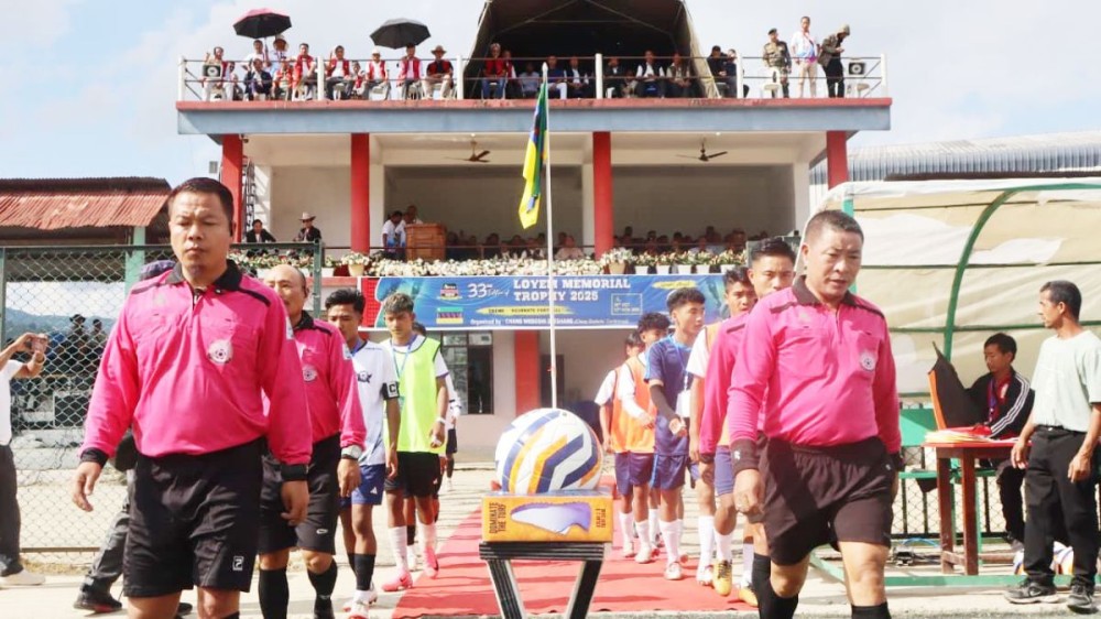 Match officials and players of Oilek FC and GHSS Hakushang School FC enter the ground for the inaugural match of the 33rd edition of the Loyem Memorial Trophy 2025 at the Loyem Memorial Astro-Turf Ground, Tuensang, on October 28. (Photo Courtesy: CWS)