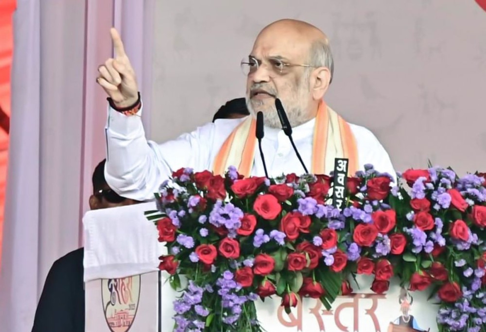 Bastar: Union Home and Cooperation Minister Amit Shah addresses during the “Bastar Dussehra Lokotsav” at the Swadeshi Mela in Jagdalpur, Bastar, Chhattisgarh on Saturday, October 04, 2025. (Photo: IANS)