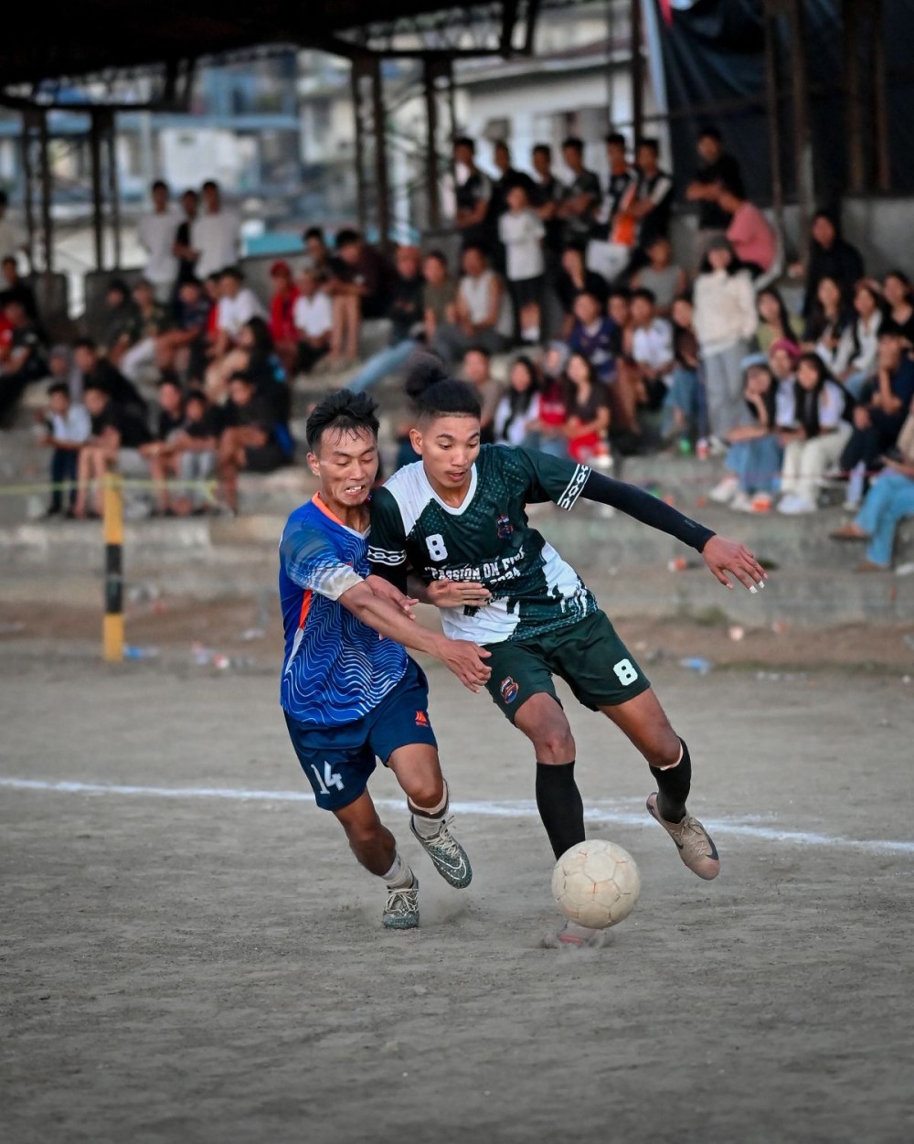 NU Lumami captain Neilei (in blue) challenges Doyang Strikers’ defender Toka Achumi (in green) during their Day 5 match of the 27th MDFA Trophy 2025 at Imkongmeren Sports Complex, Mokokchung, on October 18.