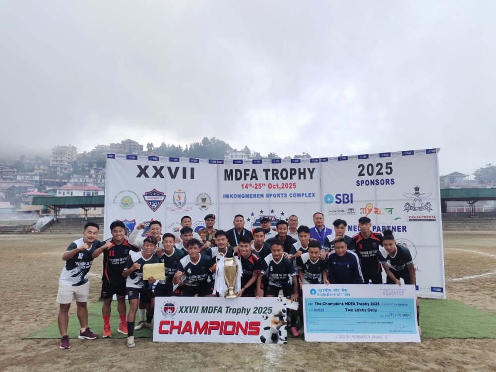 Champions Doyang Strikers Mokokchung pose with the MDFA Trophy 2025 alongside tournament officials and dignitaries after the final match at Imkongmeren Sports Complex, Mokokchung, on October 25.